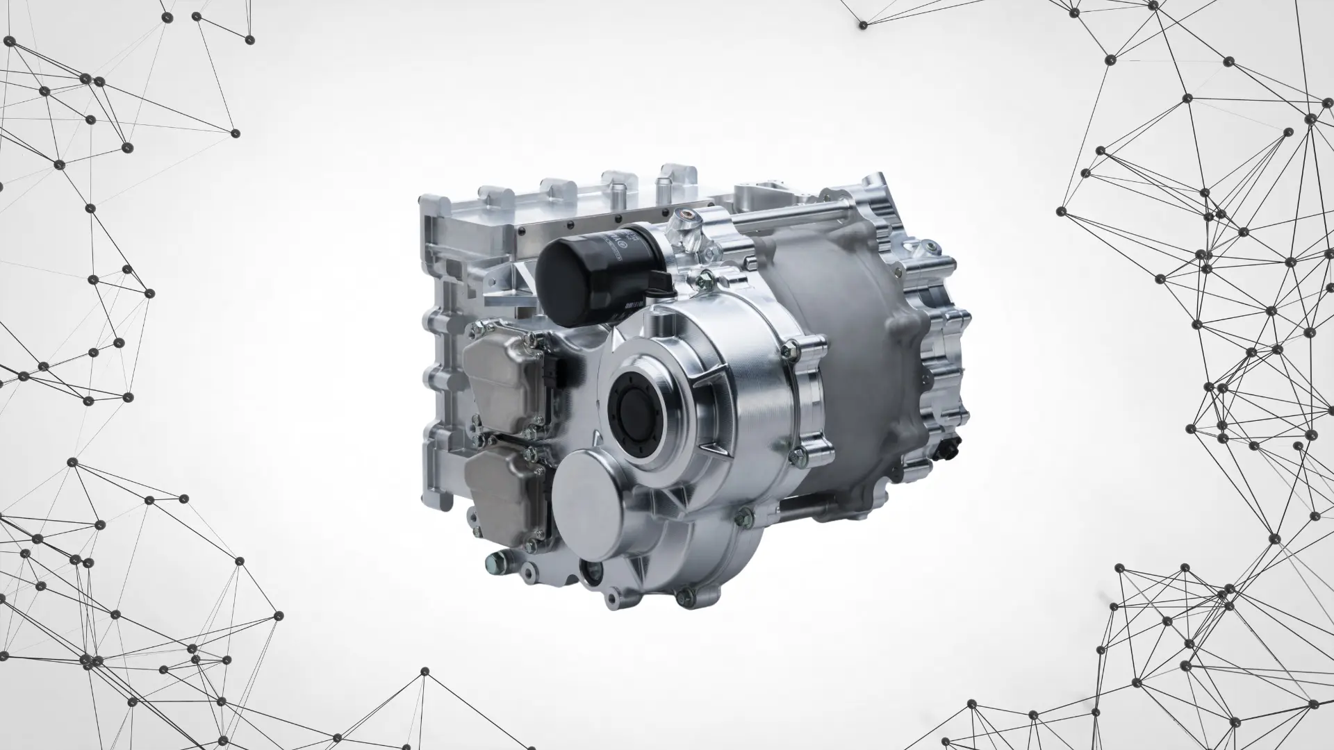 close-up of a compact electric vehicle motor unit with aluminum casing, drive shaft, and integrated transmission housing